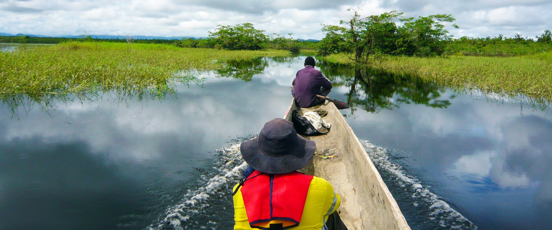 BMT environmental engineers in a canoe on a river in Papua New Guinea