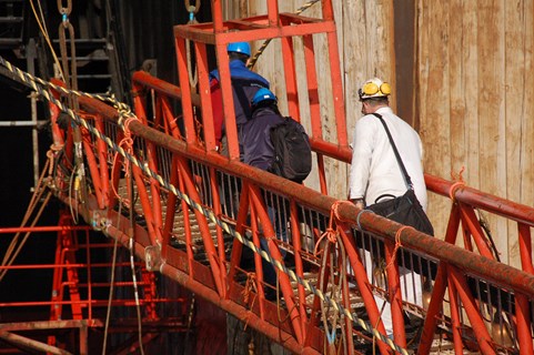 Engineer crossing a red bridge