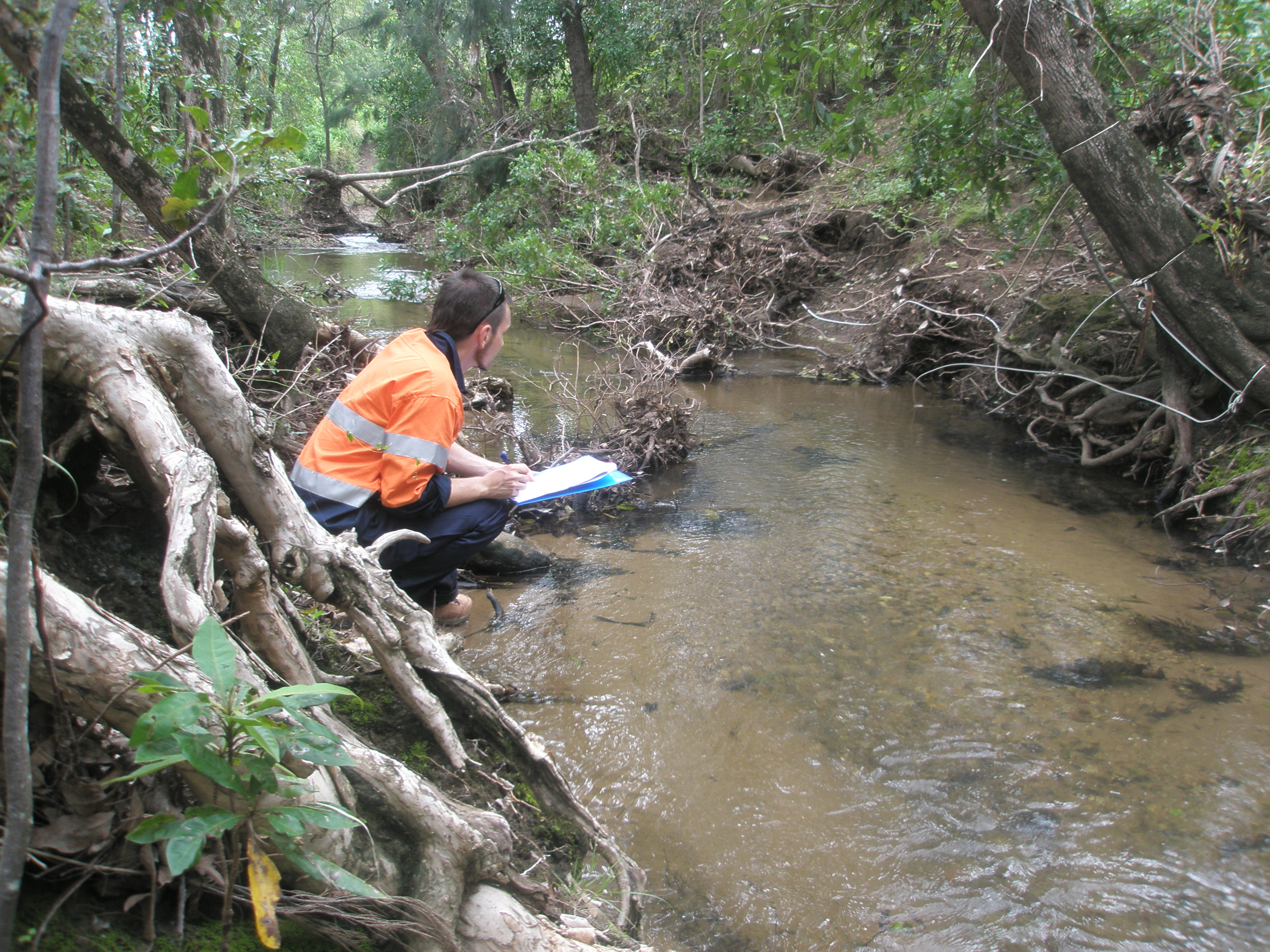 An environmental engineering running tests in a stream