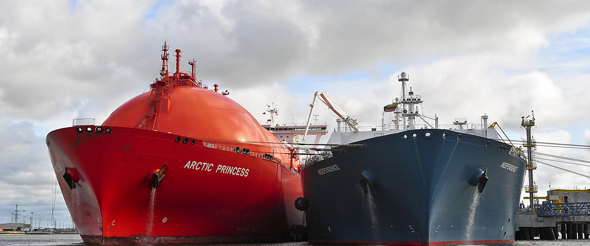 A Liquified Natural Gas vessel alongside another vessel in port