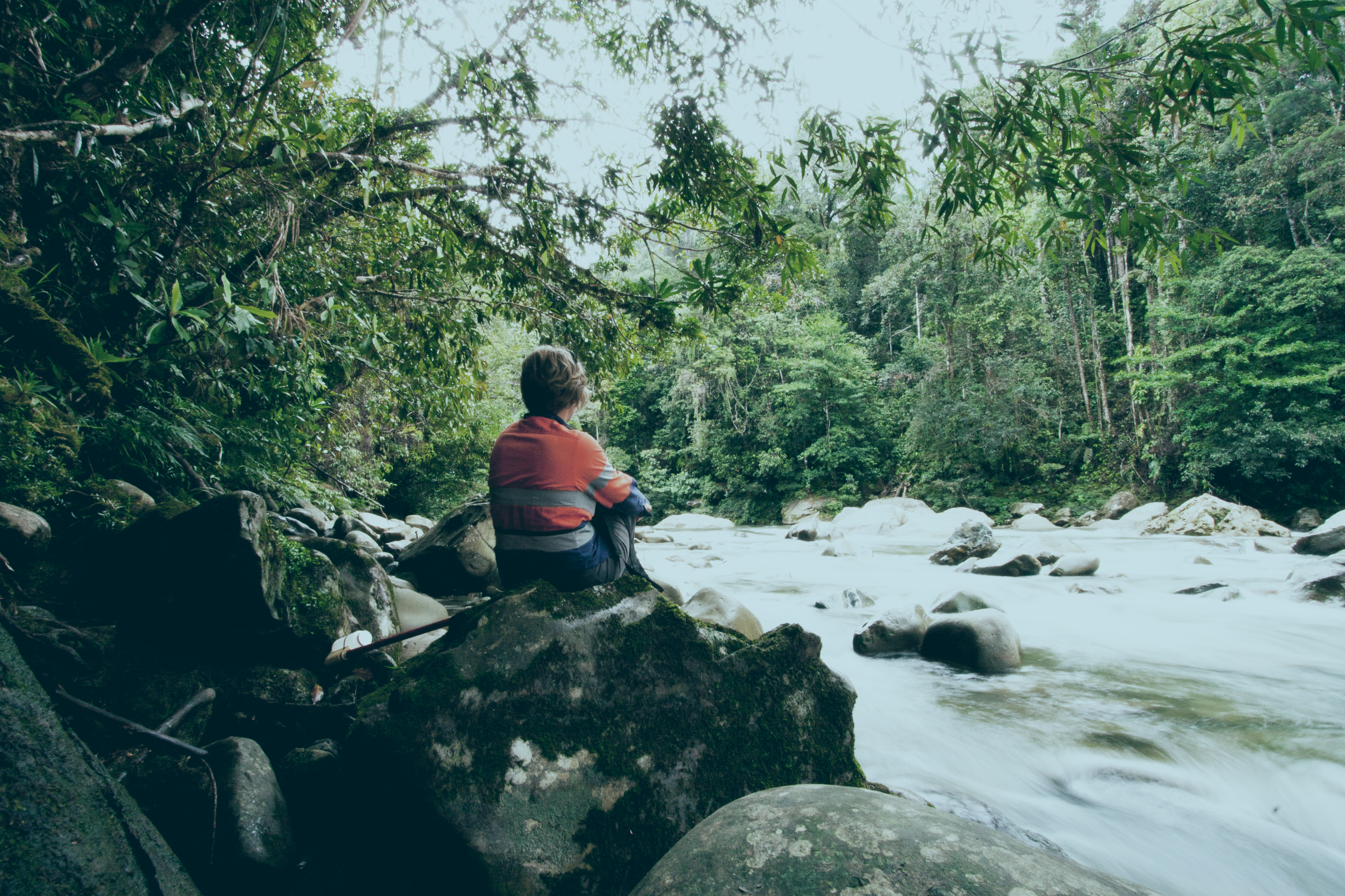 An image of an environmental engineering taking samples from a river