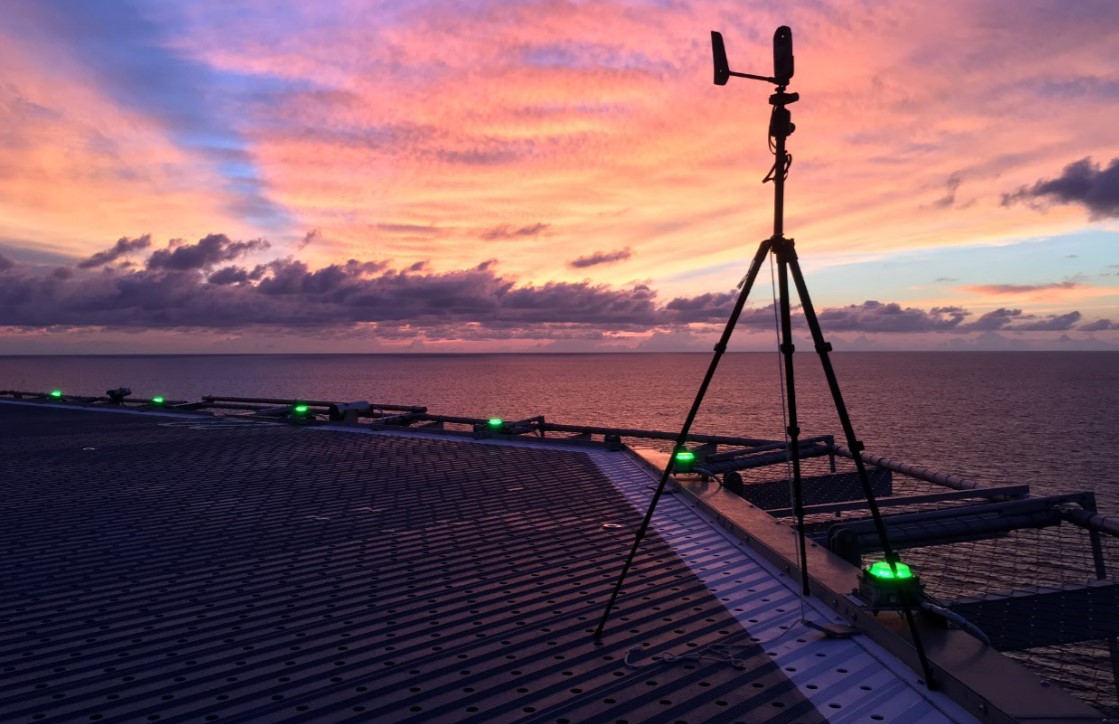 Image of a helideck on an offshore oil and gas platform at dusk