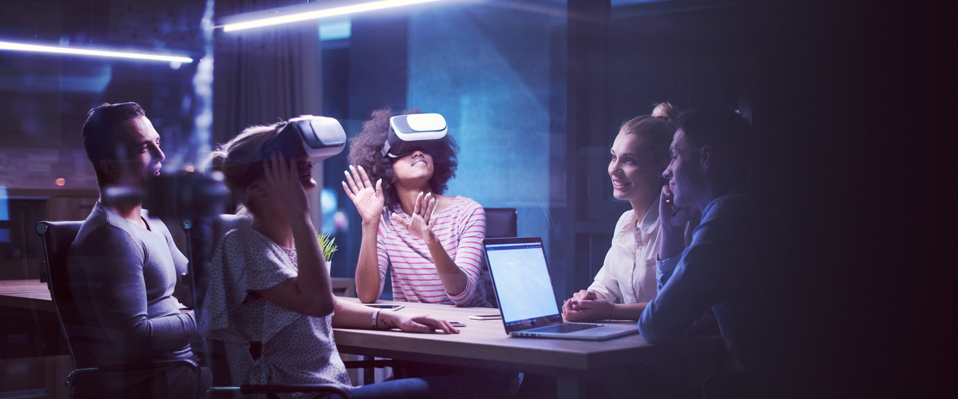 A group of people in a meeting using virtual reality headsets