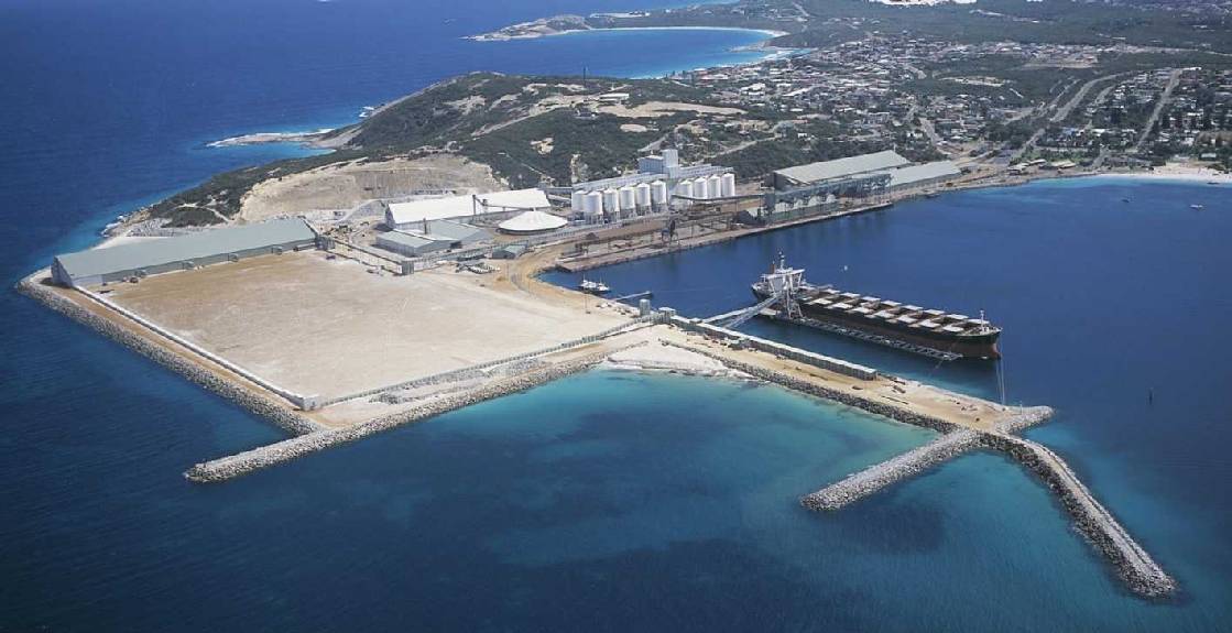 An aerial picture of a ship docked at a jetty