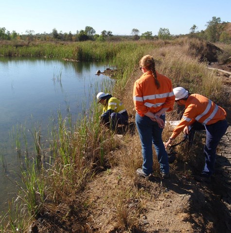 Environmental engineers taking samples from a lake