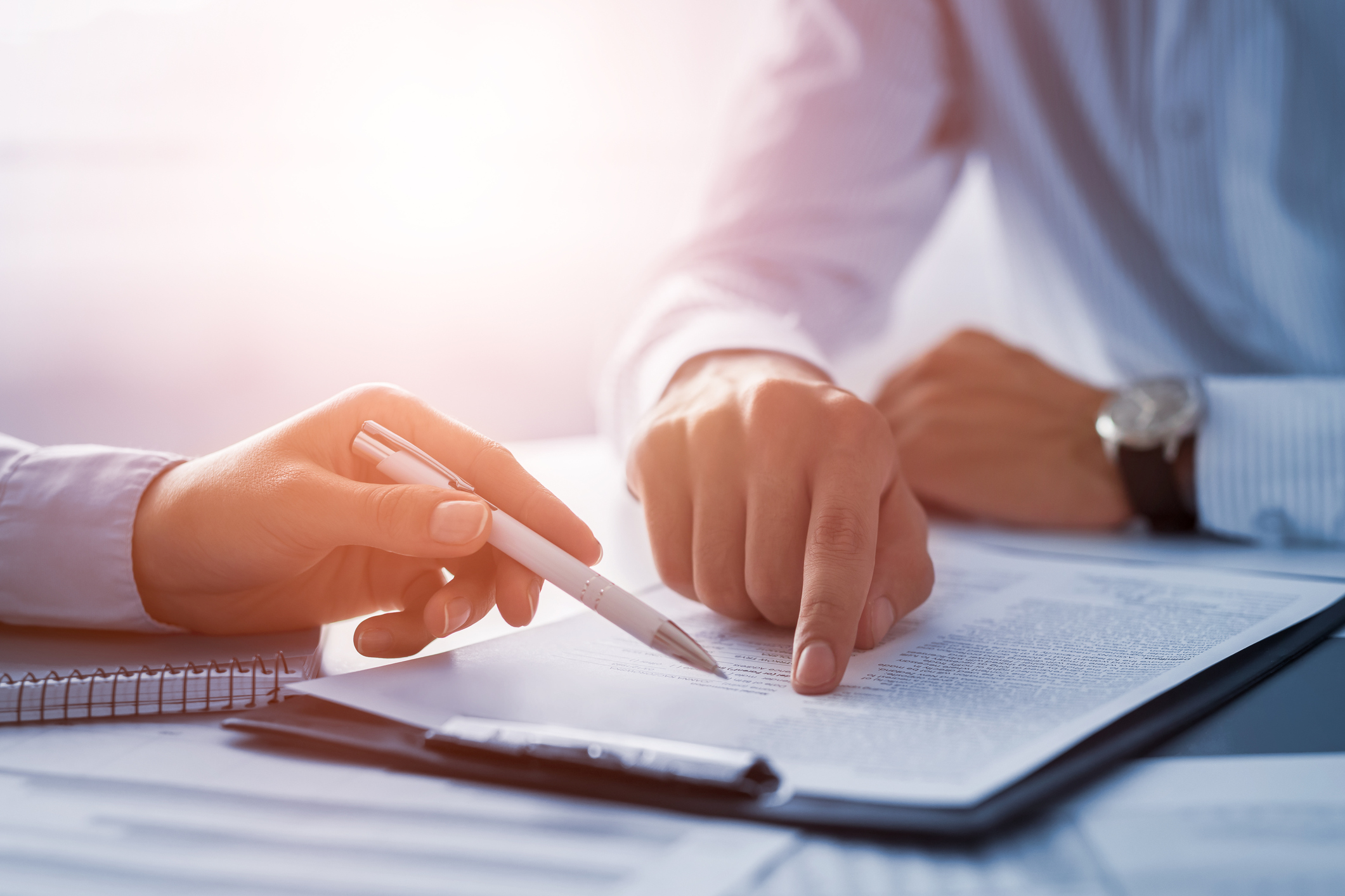 Image of two people discussing a piece of paper