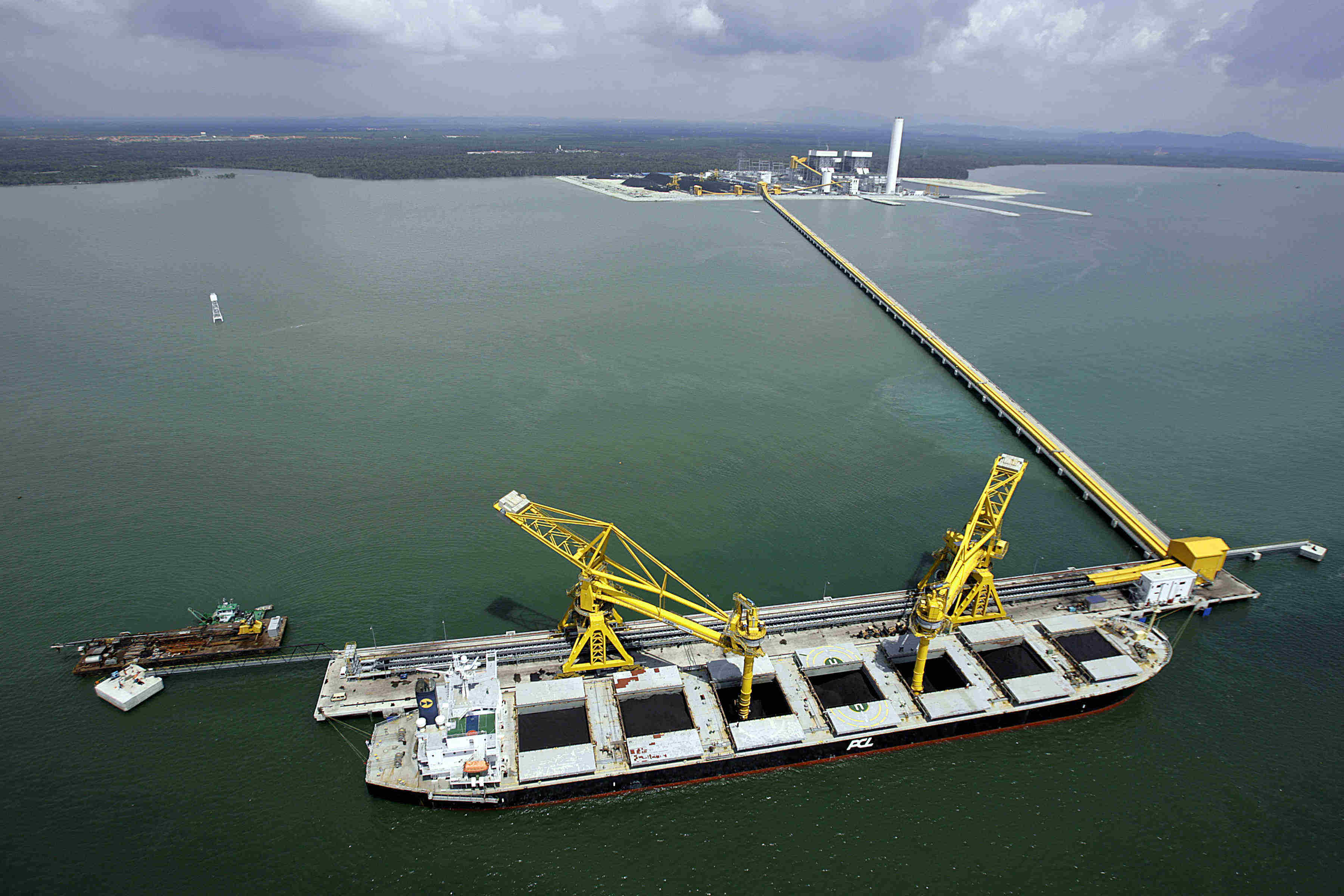 A picture of a ship moored at a jetty at sea