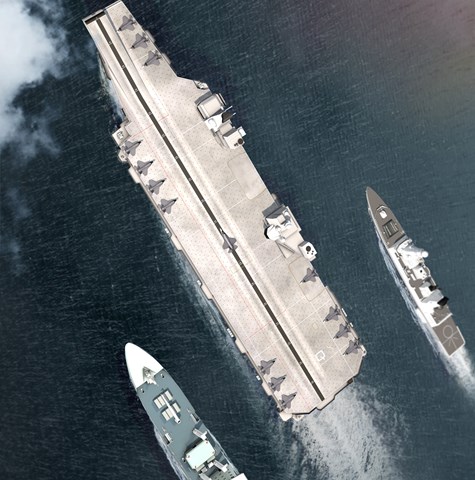 Flanked aircraft carrier at sea