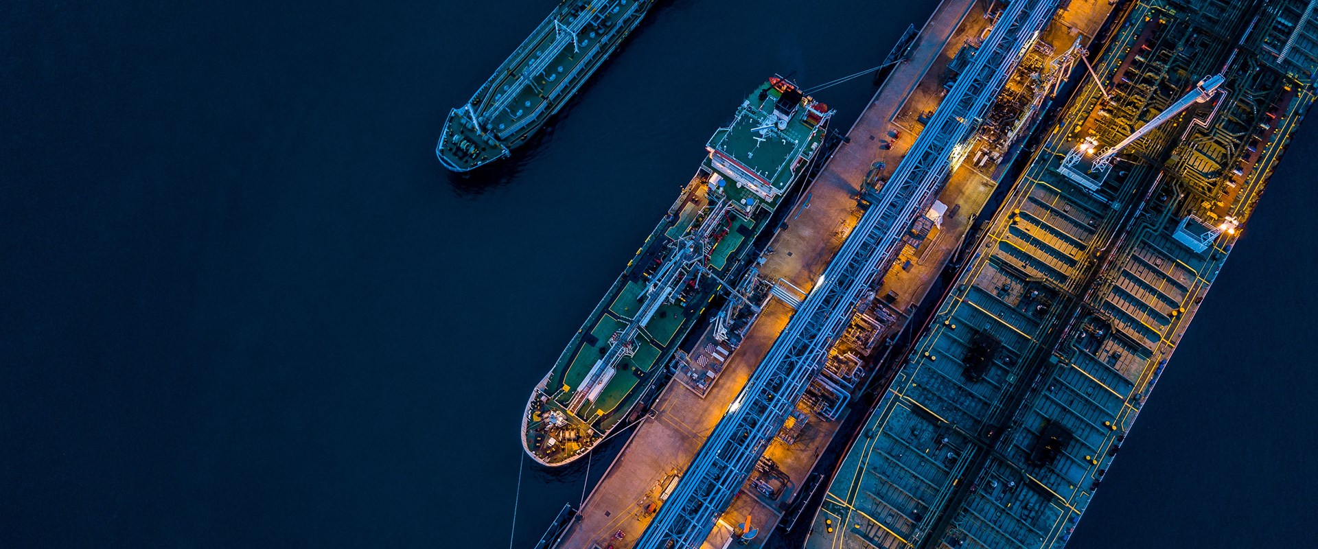 An aerial image of ships moored in a port at night