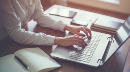 Fingers operating laptop board