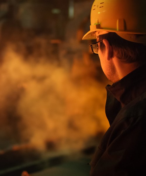 Image of a fire inspector looking over a live industrial fire
