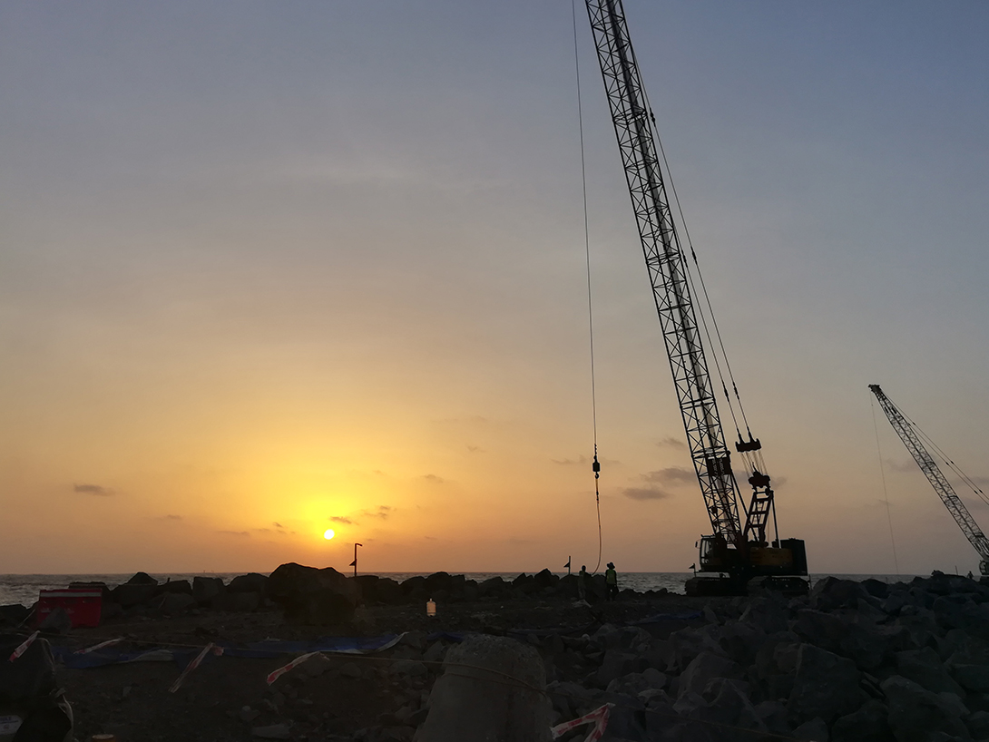 Construction crane in sunset silhouette