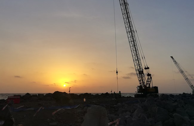 Construction crane in sunset silhouette