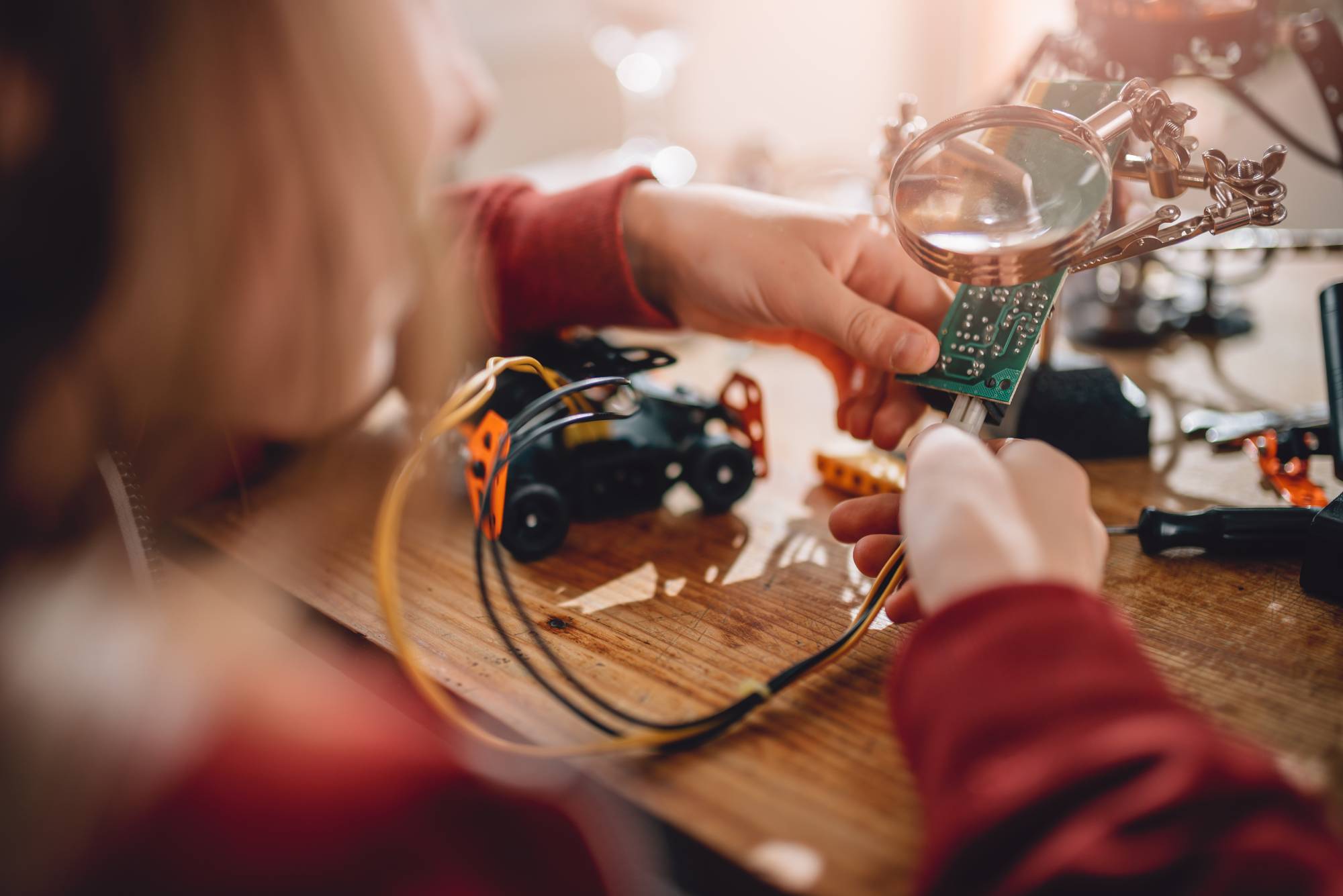 Children taking part in a STEM project and putting together a circuit board with lego