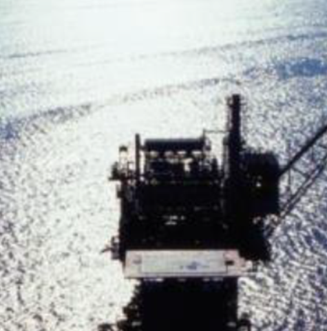 Offshore rig in sunlight with deep blue sea background