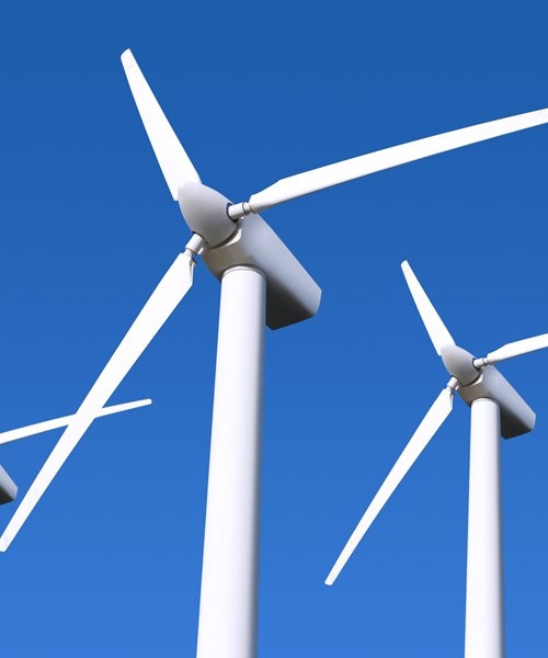 Wind farm turbines in blue sky background