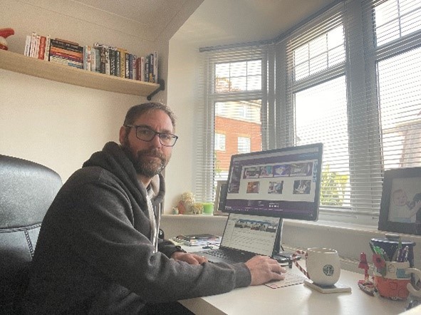 An image of Lee Rhodes sitting at his home desk