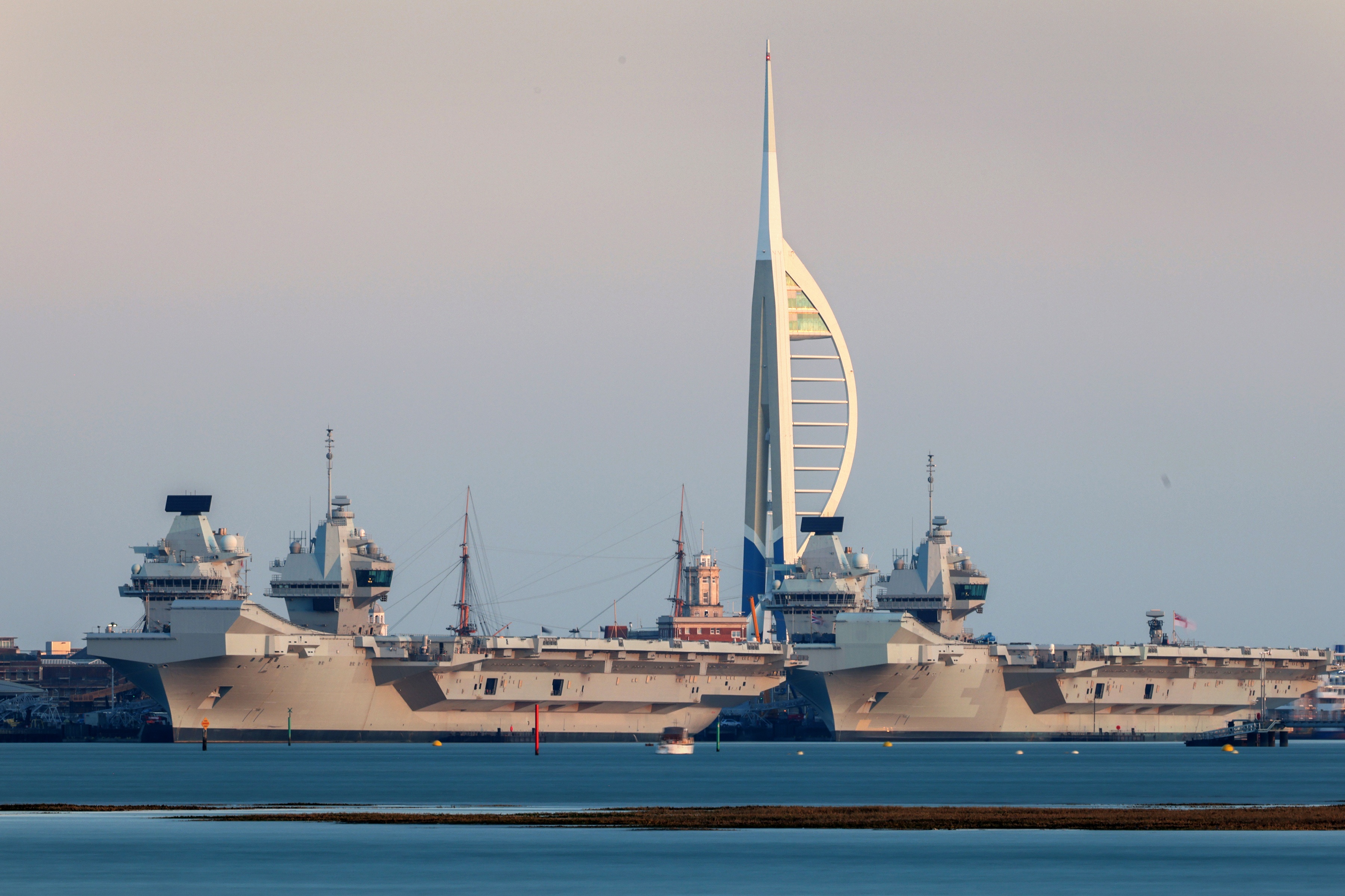 An image of the Queen Elizabeth Aircraft Carrier in Portsmouth harbour which will use BMT's REMBRANDT tug simulator for training