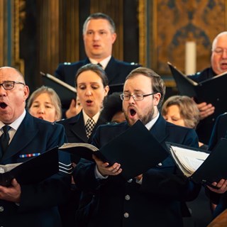 Members of the Metropolitan Police Choir singing in a church