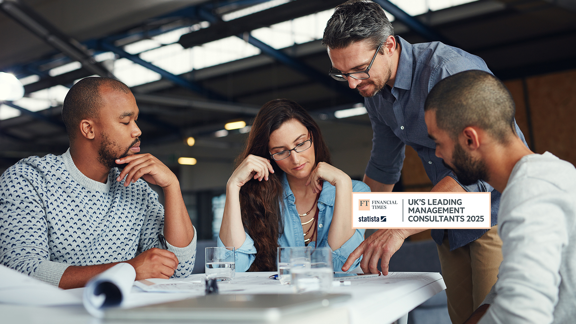 A diverse group of men and women working around a table.