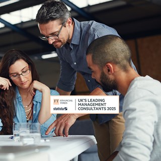 A diverse group of men and women working around a table.