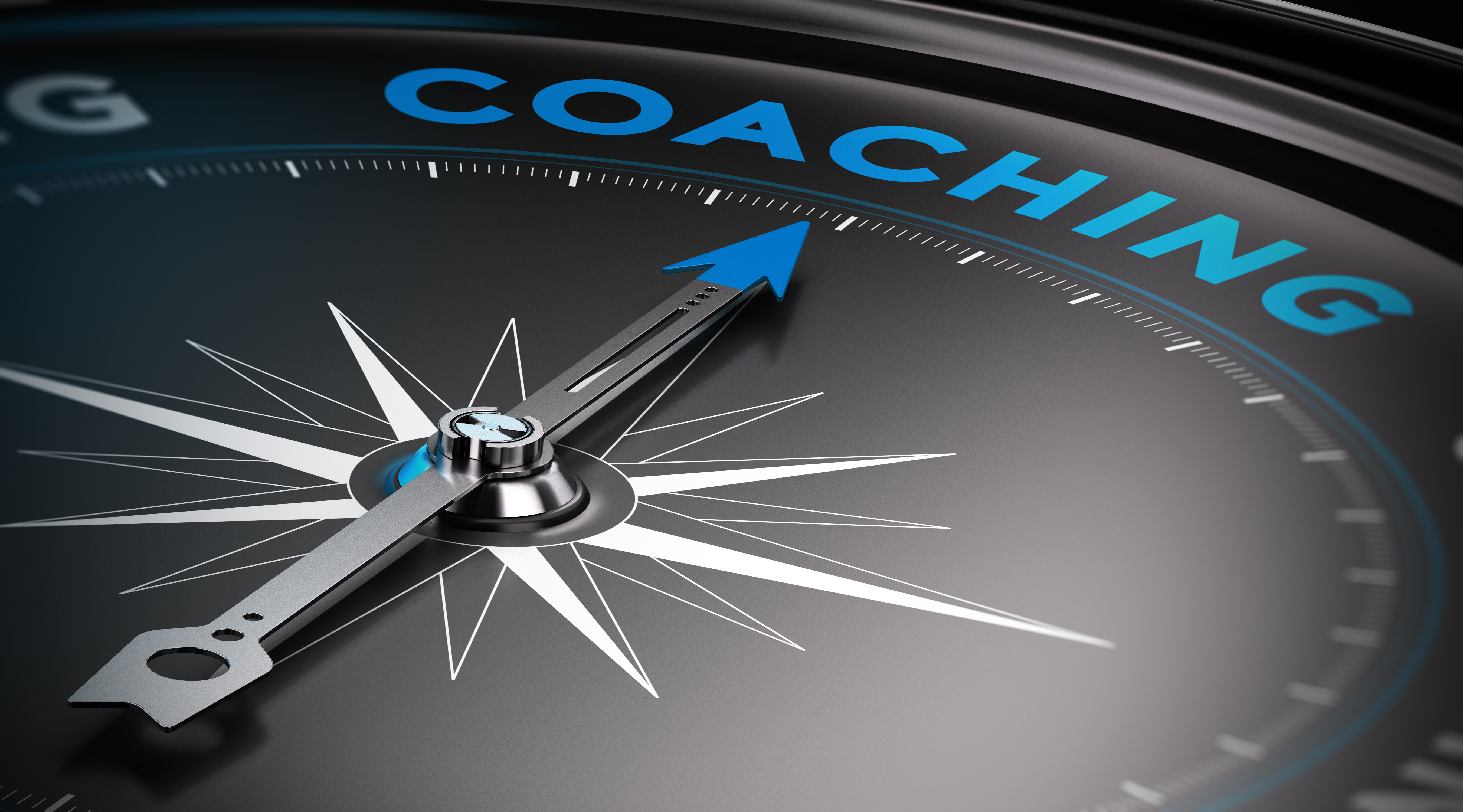 A compass pointing to the word coaching