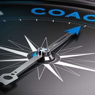 A compass pointing to the word coaching